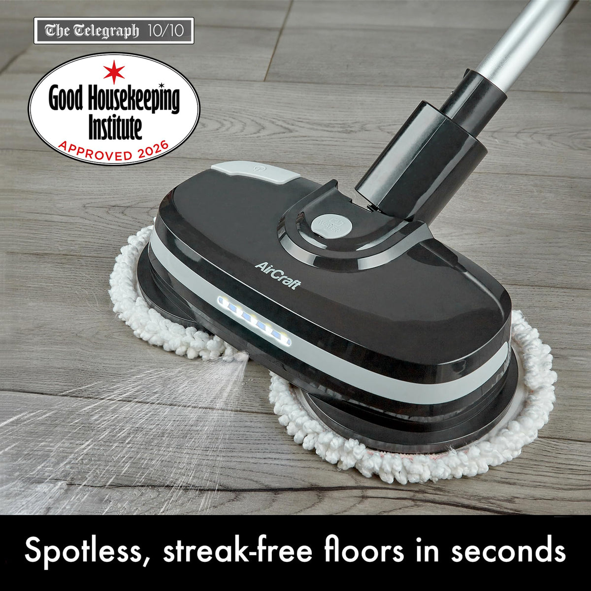 Close-up of PowerGlide head on wood floor showing LED lights, water spray and Good Housekeeping approval badge