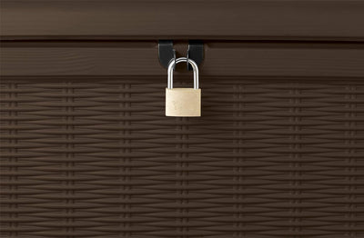 Close-up of brass padlock secured to the storage box lock loop on rattan-effect front