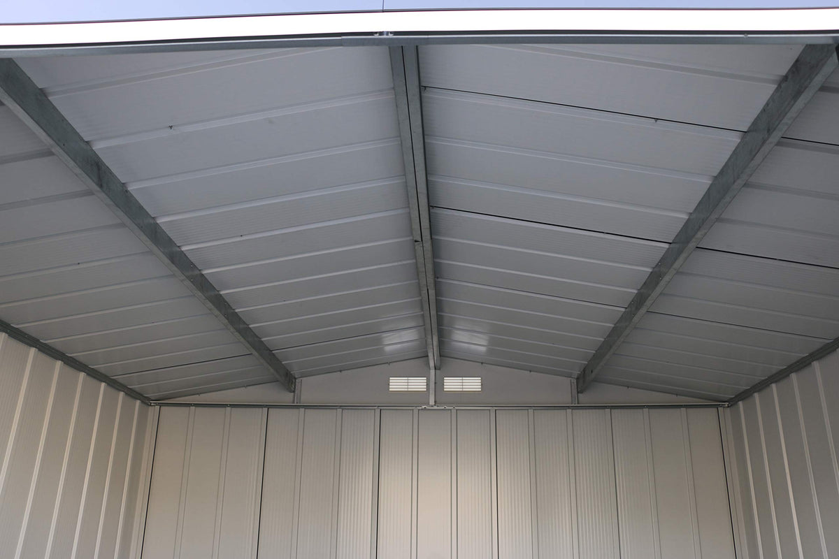 Wide interior view of the shed ceiling with central steel support, ribbed panels and gable vents