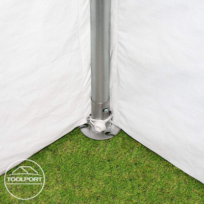 Corner base plate with vertical pole anchored to grass and secured with a grommeted cord