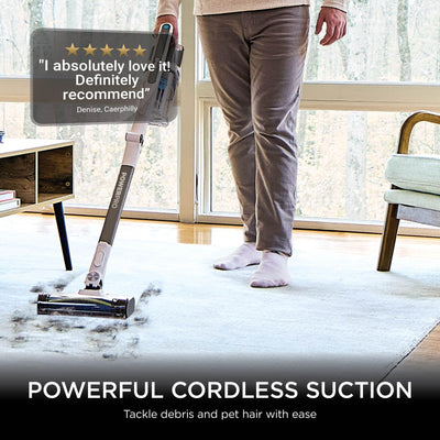 Person using the Shark stick on a rug with a five‑star customer review overlay saying “I absolutely love it! Definitely re…